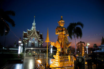 Statue of illuminated building against sky at night