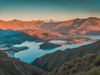 Scenic view of lake against sky during sunset