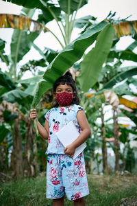 Full length of child standing on tree