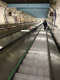 Low angle view of people on escalator