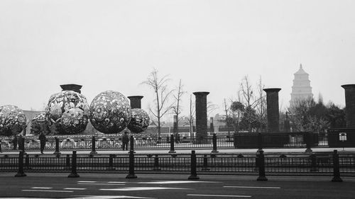 Rear view of woman sitting on park against clear sky
