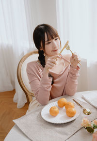 Portrait of cute girl eating food at home