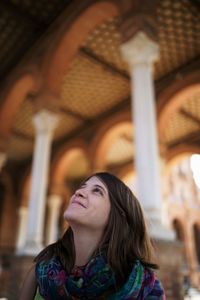 Beautiful young woman looking up