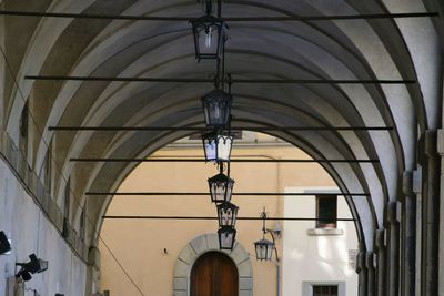 Low angle view of illuminated lights hanging on ceiling in building