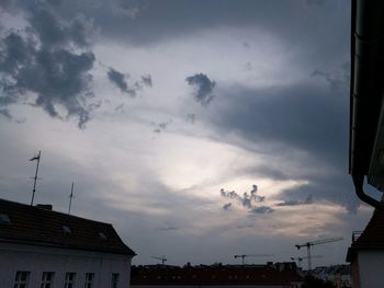 Low angle view of buildings against cloudy sky