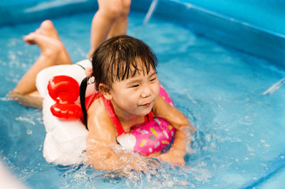 High angle view of boy swimming in pool