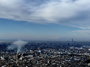 High angle view of city against cloudy sky