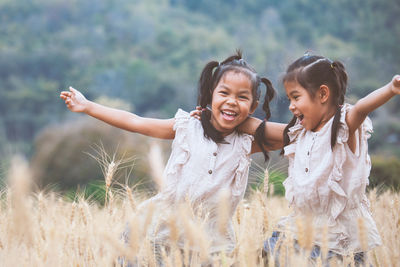 Portrait of happy girl on field