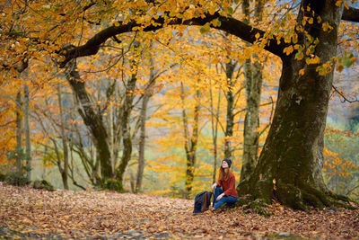 Man sitting in park during autumn