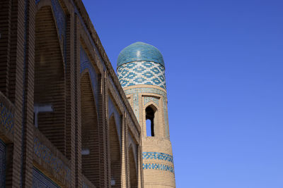 Low angle view of building against clear blue sky