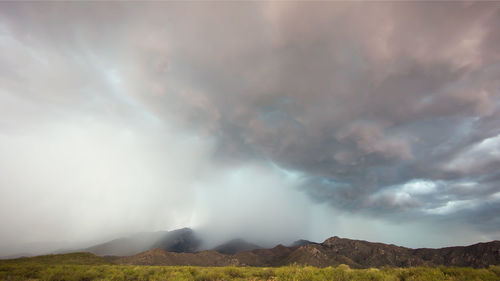 Scenic view of mountain against cloudy sky