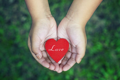 Cropped hands of person holding heart shape