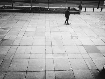 Woman standing on tiled floor