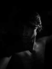 Man in contrast lighting, clear silhouette. black and white photography, with black background