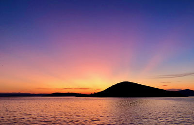 Scenic view of sea against romantic sky at sunset