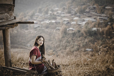 Woman with arms raised on field