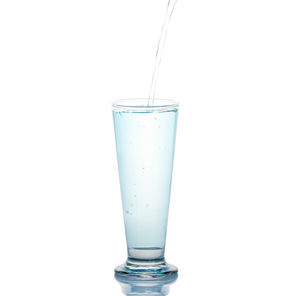 Close-up of drink in glass against white background