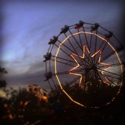 Low angle view of ferris wheel against sky at night