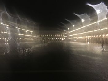 Reflection of illuminated lights on street at night