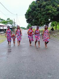 Full length of children walking on road