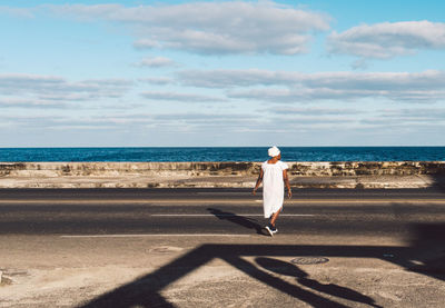 Full length of man on sea shore against sky