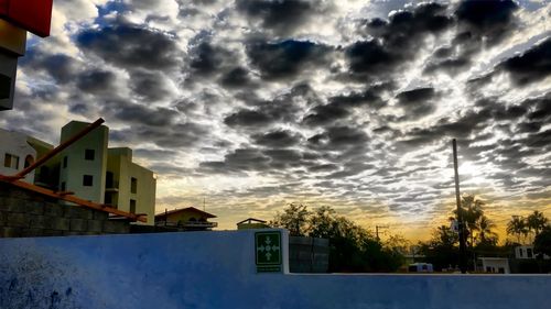 Buildings against cloudy sky