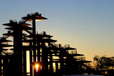 Low angle view of silhouette observation point against sky during sunset