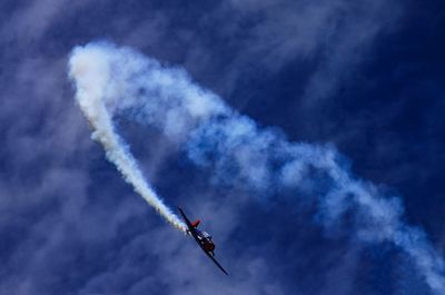 Low angle view of airplane flying in sky