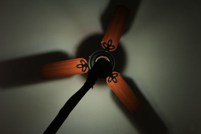 Directly below shot of cropped hand and ceiling fan