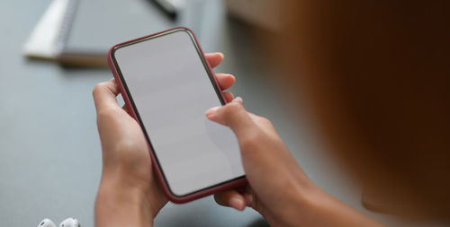 Midsection of woman using mobile phone