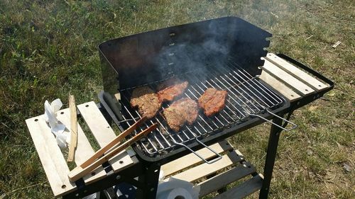 High angle view of meat being cooked on barbecue grill