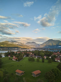 High angle view of townscape by sea against sky during sunset