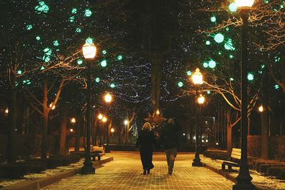 Man on illuminated street at night