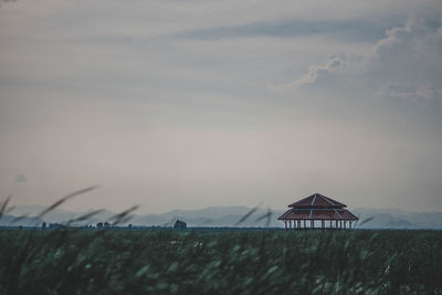 House on field against sky