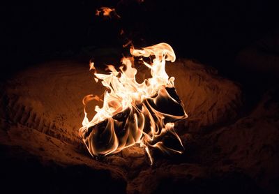 Close-up of fire on sand at beach