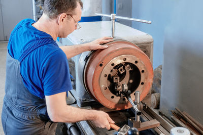 Side view of man working in workshop