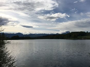 Scenic view of lake and mountains against sky