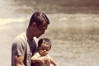 Father with son walking by lake