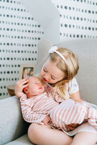 Closeup portrait of two sisters sitting together in a rocking chair