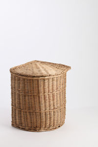 Close-up of wicker basket over white background