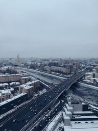 Aerial view of highway amidst buildings in city against sky