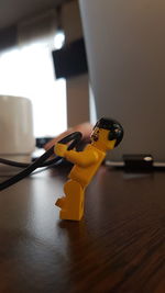 Close-up of yellow toy on table at home