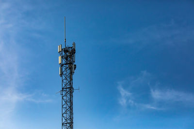 Low angle view of communications tower against sky