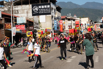 Group of people walking on road in city