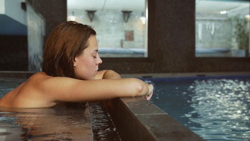 Close-up of young woman swimming in pool