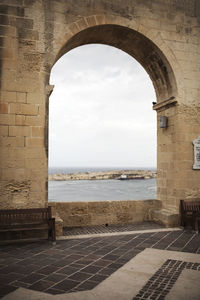 Scenic view of sea against sky seen through arch window