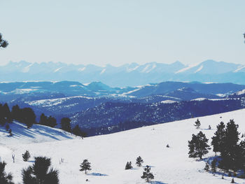 Scenic view of snow covered mountains against sky