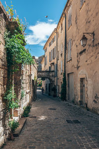 Narrow alley amidst old buildings in city