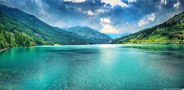 Scenic view of swimming pool by lake against sky