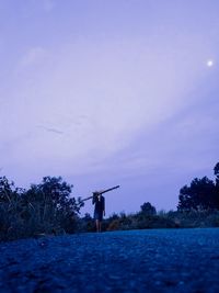 Man standing on field against sky